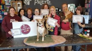 PCPSI employees holding their Pet First Aid 4U Certificates for training in pet care