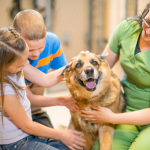 Dallas shelter volunteer with two children and an adoptable dog