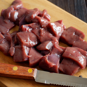 beef livers on a cutting board with a knife dallas pet treats