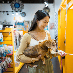 dog owner in Dallas pet supply store with her dog in her arms