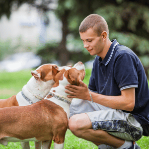 young man with two dogs in Dallas, Texas